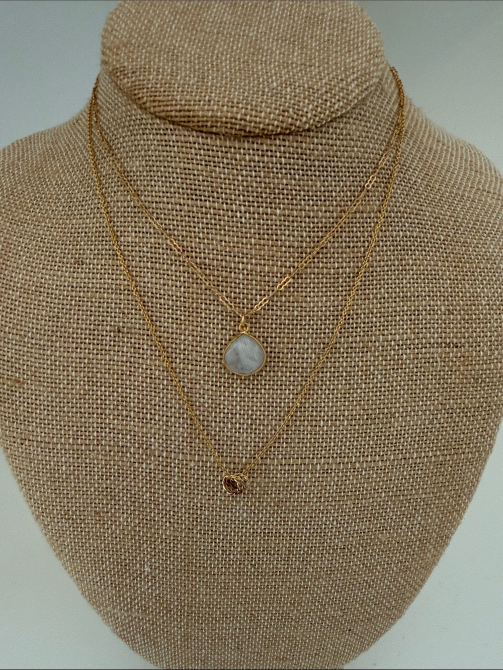 Two gold color necklaces - one with White Stone Pendant - one three circles